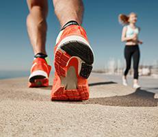 Close-up of a runner's foot mid-stride wearing an athletic shoe outdoors