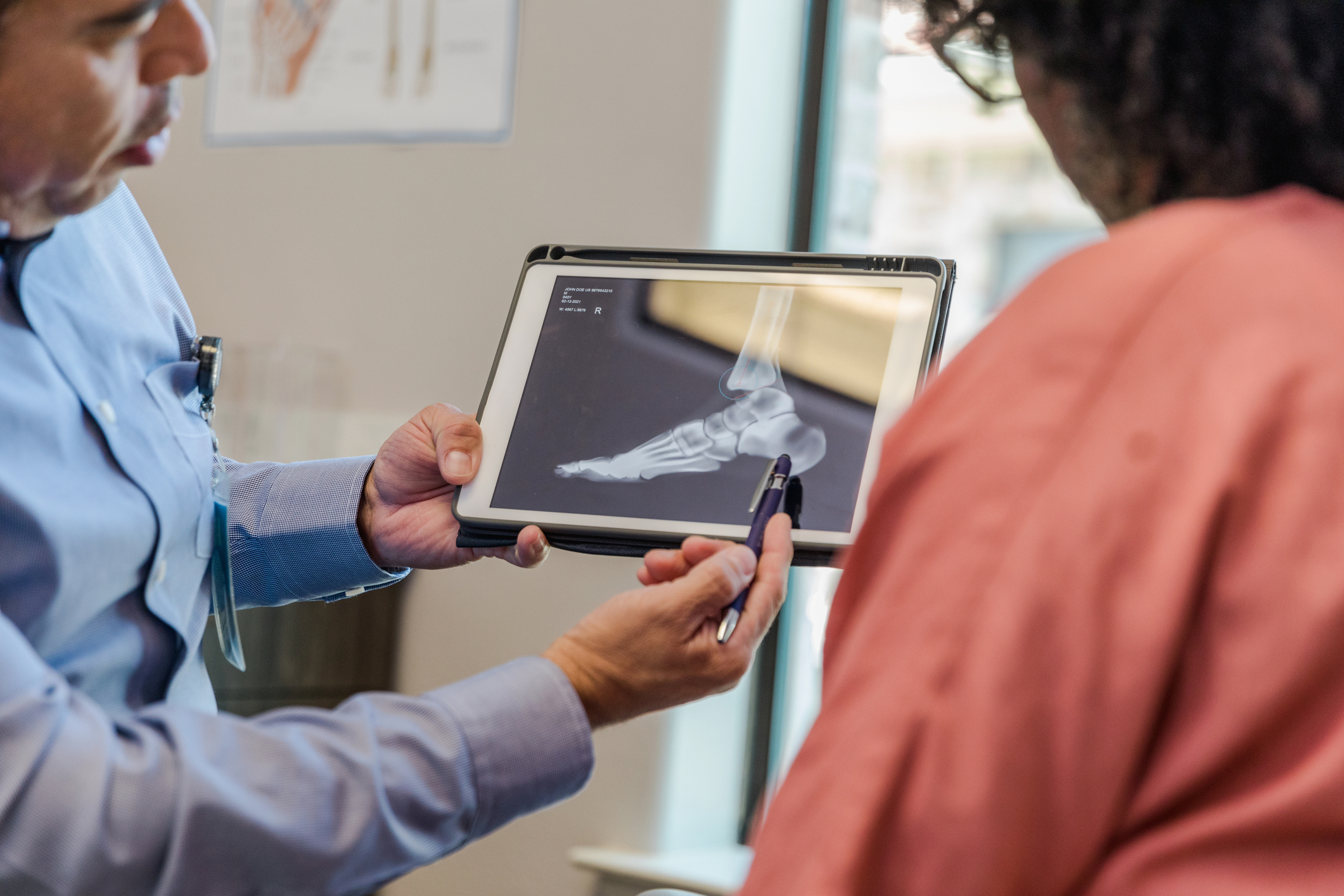 Podiatrist examining patient foot during a routine clinical check-up