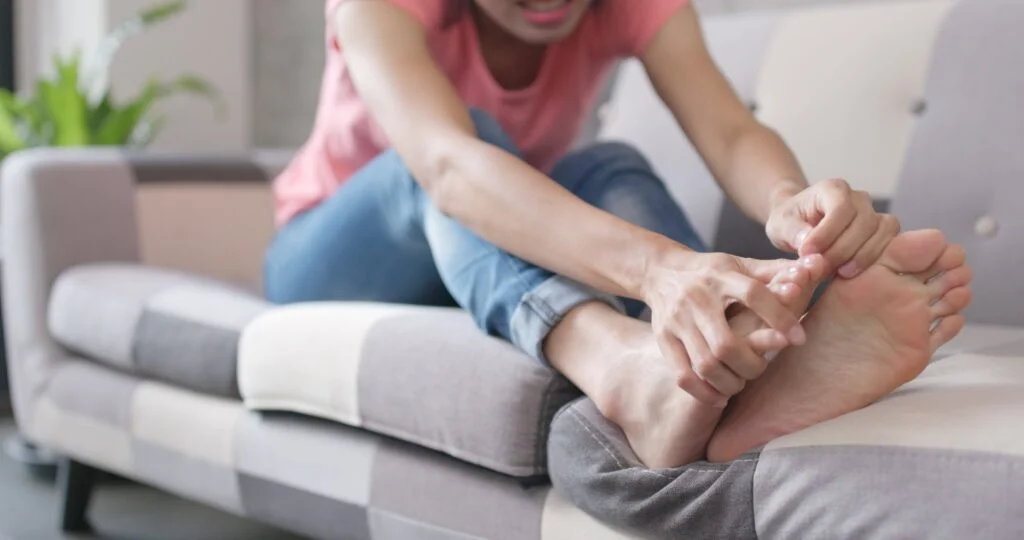 Person holding their foot