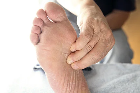 Person holding their foot